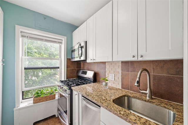 30 Clinton Pl Unit 2F, New Rochelle, NY 10801 - kitchen with appliances with stainless steel finishes, tasteful backsplash, white cabinets, and light stone counters