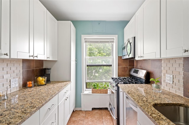 30 Clinton Pl Unit 2F, New Rochelle, NY 10801 - kitchen with appliances with stainless steel finishes, white cabinets, and light stone counters