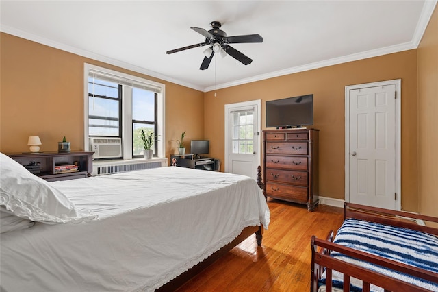 30 Clinton Pl Unit 2F, New Rochelle, NY 10801 - bedroom featuring radiator heating unit, multiple windows, ornamental molding, wood finished floors, and cooling unit