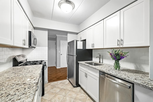 370 Central Park Ave Unit 3D, Scarsdale, NY 10583 - kitchen with stainless steel appliances, white cabinets, backsplash, and light stone countertops