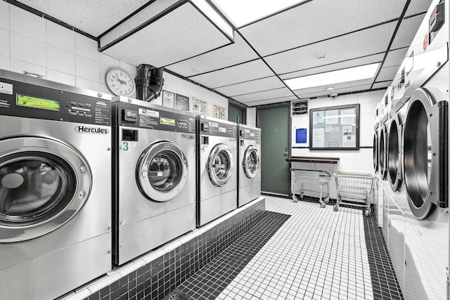 370 Central Park Ave Unit 3D, Scarsdale, NY 10583 - community laundry featuring washing machine and clothes dryer and tile patterned floors