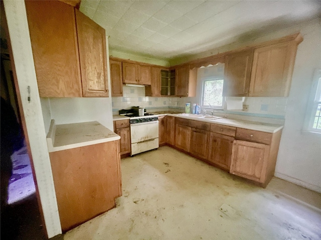 94 Sickle Rd, Wurtsboro, NY 12790 - kitchen with white gas range oven, decorative backsplash, light countertops, and unfinished concrete flooring