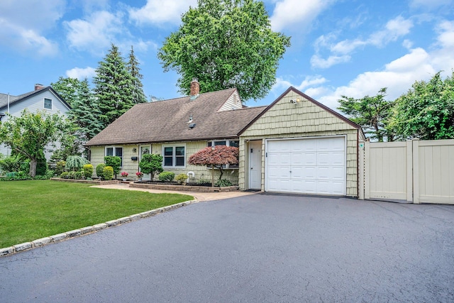 19 Buttercup Ln, Levittown, NY 11756 - view of front facade featuring driveway, an attached garage, a chimney, and a shingled roof