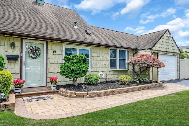 19 Buttercup Ln, Levittown, NY 11756 - view of front of home featuring roof with shingles and a garage