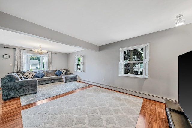 19 Buttercup Ln, Levittown, NY 11756 - living area with a baseboard heating unit, wood finished floors, and a chandelier
