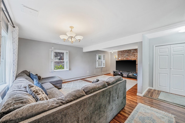 19 Buttercup Ln, Levittown, NY 11756 - living area with a baseboard heating unit, a chandelier, and wood finished floors