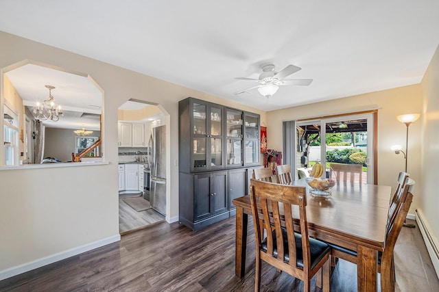19 Buttercup Ln, Levittown, NY 11756 - dining room with arched walkways, dark wood finished floors, ceiling fan, a chandelier, and a baseboard heating unit