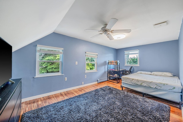 19 Buttercup Ln, Levittown, NY 11756 - bedroom with a baseboard heating unit, wood finished floors, lofted ceiling, and ceiling fan