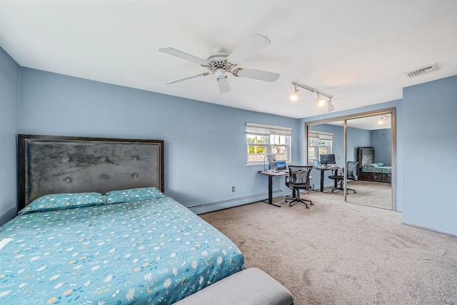19 Buttercup Ln, Levittown, NY 11756 - bedroom featuring a baseboard heating unit, carpet floors, a desk, track lighting, and a closet