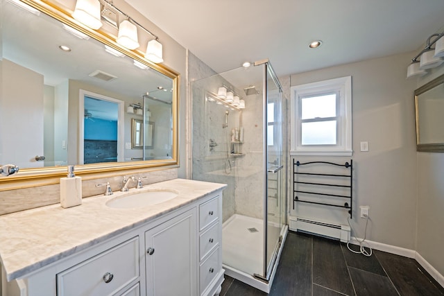 19 Buttercup Ln, Levittown, NY 11756 - full bathroom with a baseboard radiator, vanity, a shower stall, wood finished floors, and recessed lighting