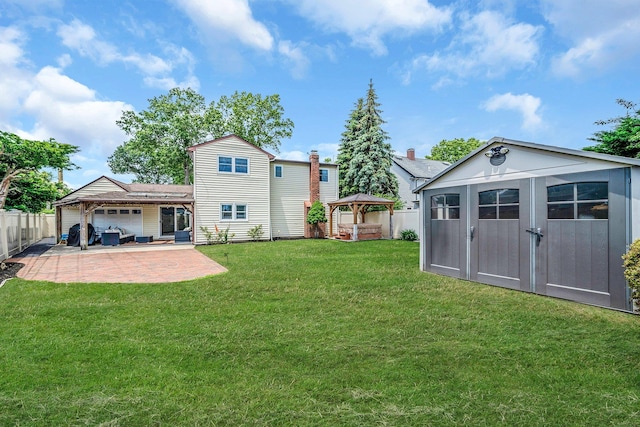 19 Buttercup Ln, Levittown, NY 11756 - back of property featuring a gazebo, a fenced backyard, a patio area, and a storage unit