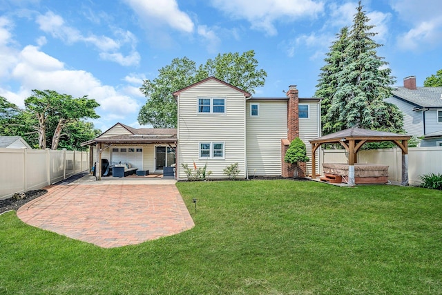 19 Buttercup Ln, Levittown, NY 11756 - rear view of property with a hot tub, a gazebo, a fenced backyard, and a garage