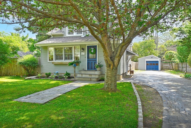 15 5th Ave, Kings Park, NY 11754 - view of front facade featuring driveway, an outbuilding, a detached garage, and roof with shingles