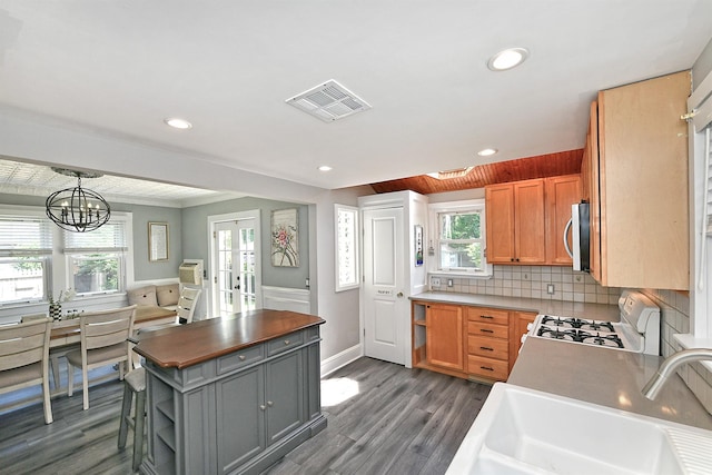 15 5th Ave, Kings Park, NY 11754 - kitchen with white range with gas cooktop, dark wood-style floors, stainless steel microwave, french doors, and open shelves