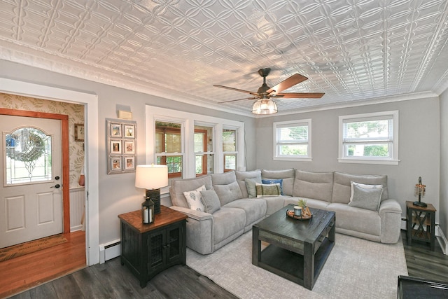 15 5th Ave, Kings Park, NY 11754 - living room featuring an ornate ceiling, a baseboard heating unit, ornamental molding, wood finished floors, and ceiling fan