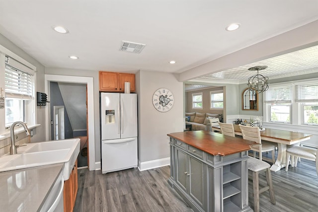 15 5th Ave, Kings Park, NY 11754 - kitchen with white appliances, dark wood-style flooring, recessed lighting, a chandelier, and brown cabinets