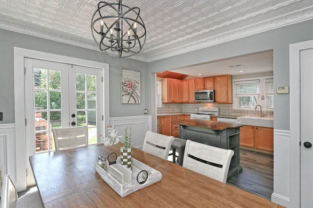 15 5th Ave, Kings Park, NY 11754 - dining space with an ornate ceiling, french doors, wood finished floors, ornamental molding, and a chandelier