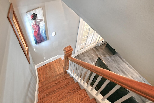 15 5th Ave, Kings Park, NY 11754 - staircase with a baseboard heating unit and wood finished floors