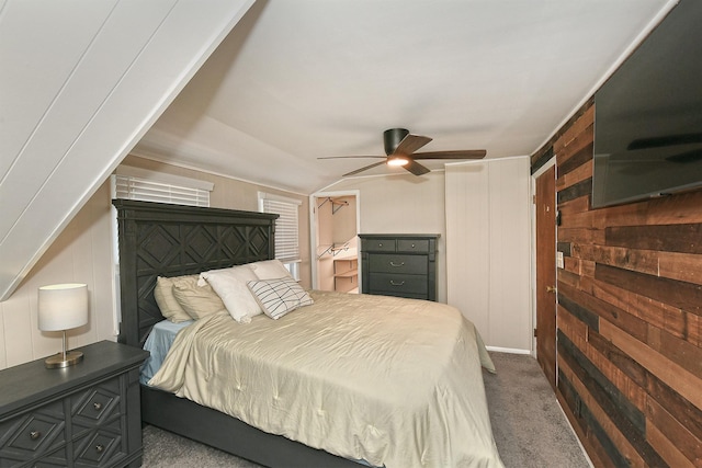15 5th Ave, Kings Park, NY 11754 - bedroom with dark carpet, wood walls, a ceiling fan, and lofted ceiling