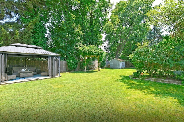 15 5th Ave, Kings Park, NY 11754 - fenced backyard with a gazebo, a storage shed, and outdoor lounge area