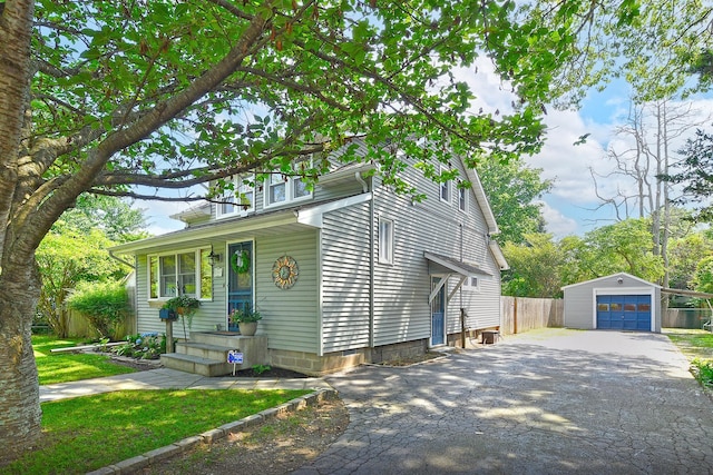 15 5th Ave, Kings Park, NY 11754 - view of front facade with an outdoor structure, a garage, and driveway