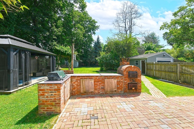 15 5th Ave, Kings Park, NY 11754 - fenced backyard featuring an outdoor kitchen, a patio, a gazebo, and a fireplace