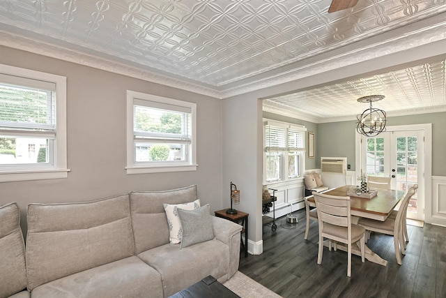 15 5th Ave, Kings Park, NY 11754 - living room featuring dark wood-style floors, plenty of natural light, an ornate ceiling, crown molding, and a wainscoted wall