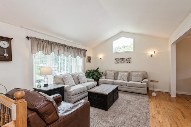 9 Phyllis Ct, Kings Park, NY 11754 - living area featuring lofted ceiling, plenty of natural light, and light wood-type flooring