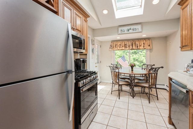 9 Phyllis Ct, Kings Park, NY 11754 - kitchen with appliances with stainless steel finishes, a skylight, recessed lighting, light tile patterned floors, and brown cabinetry