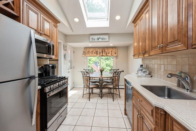 9 Phyllis Ct, Kings Park, NY 11754 - kitchen with appliances with stainless steel finishes, brown cabinetry, light countertops, and recessed lighting