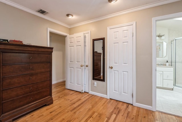 9 Phyllis Ct, Kings Park, NY 11754 - bedroom with light wood-style floors, crown molding, and ensuite bathroom