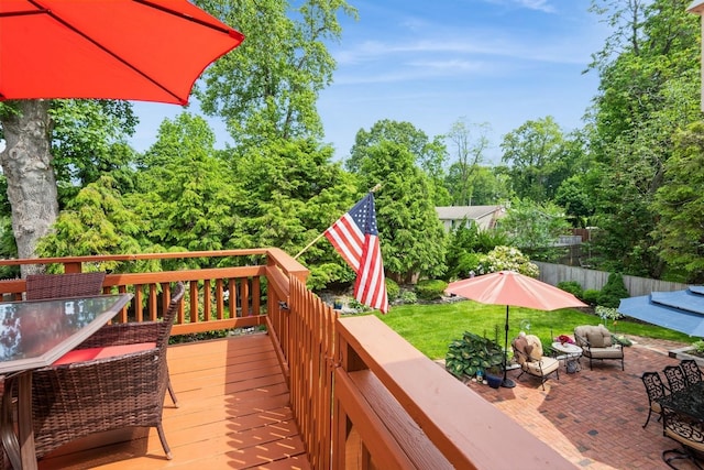 9 Phyllis Ct, Kings Park, NY 11754 - wooden deck featuring an outdoor hangout area, outdoor dining space, view of wooded area, and a patio area