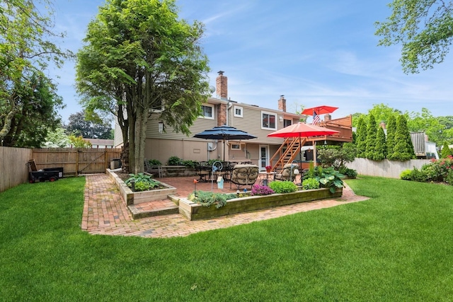 9 Phyllis Ct, Kings Park, NY 11754 - rear view of property with a chimney, a fenced backyard, a patio area, a garden, and stairs