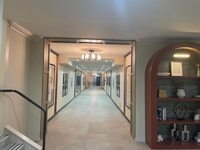 360 Central Ave Unit 218-219, Lawrence, NY 11559 - hallway with ornamental molding, arched walkways, and a chandelier