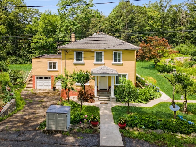 123 Pleasant Rd, Lake Peekskill, NY 10537 - view of front of property featuring driveway, stucco siding, an attached garage, and a chimney