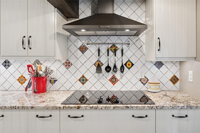 123 Pleasant Rd, Lake Peekskill, NY 10537 - kitchen featuring wall chimney exhaust hood, white cabinets, decorative backsplash, black electric cooktop, and light stone countertops