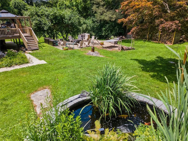 123 Pleasant Rd, Lake Peekskill, NY 10537 - view of green lawn with a small pond, a gazebo, a patio area, and stairway