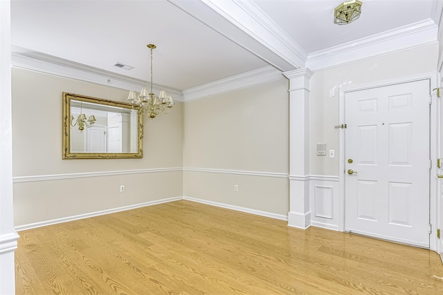 24 N De Baun Ave Unit 304, Suffern, NY 10901 - entryway featuring light wood-style floors, ornamental molding, a chandelier, and ornate columns