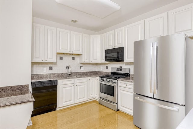 24 N De Baun Ave Unit 304, Suffern, NY 10901 - kitchen featuring black appliances, white cabinetry, dark stone counters, and tasteful backsplash