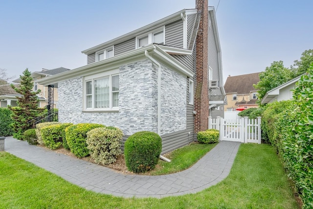 37 Keystone Pl, Hewlett, NY 11557 - view of property exterior featuring stone siding, a chimney, and a gate