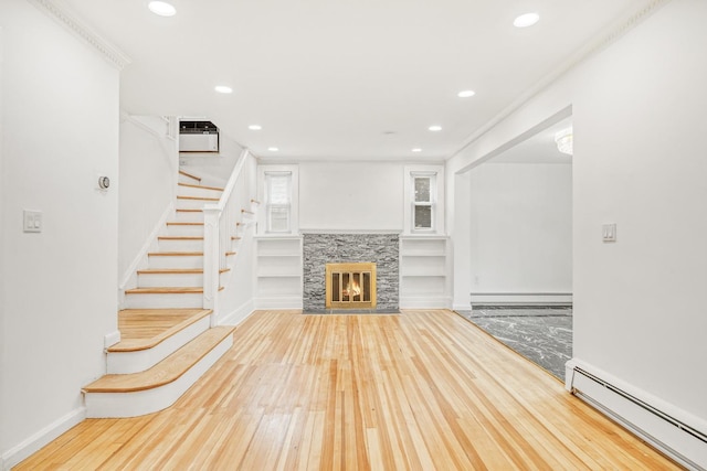 37 Keystone Pl, Hewlett, NY 11557 - unfurnished living room with a baseboard radiator, hardwood / wood-style floors, recessed lighting, stairs, and a glass covered fireplace
