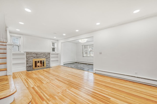 37 Keystone Pl, Hewlett, NY 11557 - unfurnished living room featuring wood finished floors, baseboard heating, recessed lighting, a baseboard heating unit, and a fireplace with flush hearth