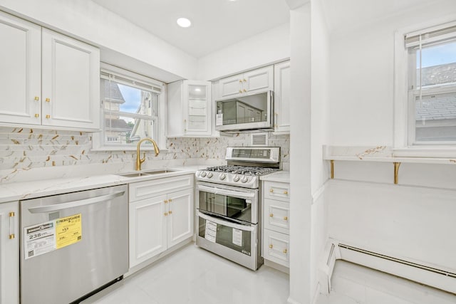37 Keystone Pl, Hewlett, NY 11557 - kitchen with stainless steel appliances, baseboard heating, decorative backsplash, white cabinetry, and recessed lighting