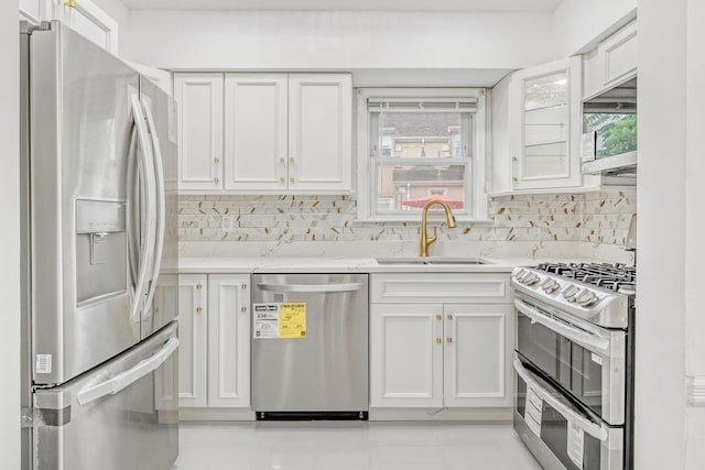 37 Keystone Pl, Hewlett, NY 11557 - kitchen with stainless steel appliances, white cabinets, decorative backsplash, and light tile patterned floors