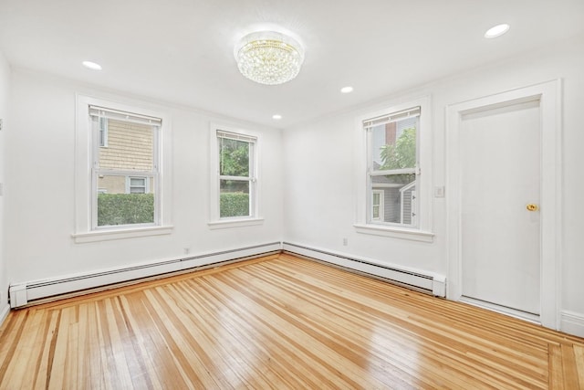 37 Keystone Pl, Hewlett, NY 11557 - spare room featuring baseboard heating, wood-type flooring, a chandelier, recessed lighting, and a baseboard radiator