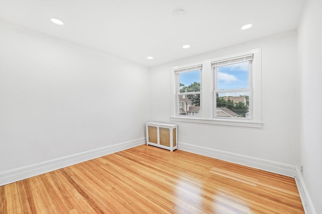 37 Keystone Pl, Hewlett, NY 11557 - spare room with radiator heating unit, light wood-style floors, and recessed lighting