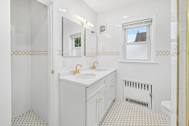 37 Keystone Pl, Hewlett, NY 11557 - bathroom with radiator, double vanity, tile walls, and tiled shower