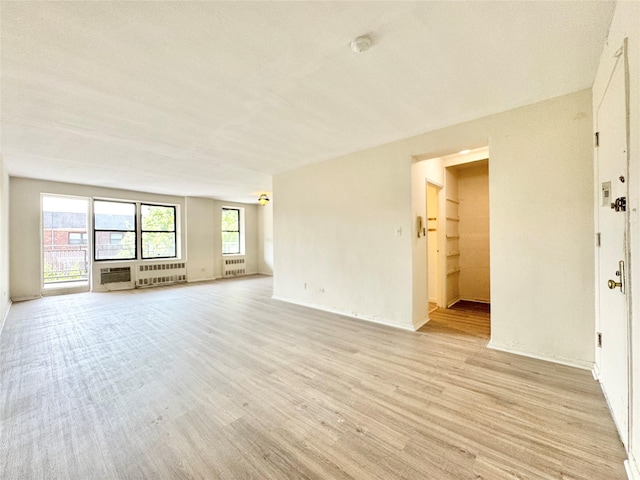 87-10 51st Ave Unit 3E, Elmhurst, NY 11373 - unfurnished room with light wood-style floors, a smoke detector, and radiator heating unit
