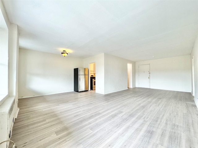 87-10 51st Ave Unit 3E, Elmhurst, NY 11373 - unfurnished living room featuring light wood-style floors
