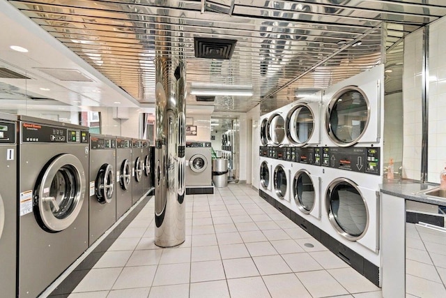 87-10 51st Ave Unit 3E, Elmhurst, NY 11373 - community laundry room featuring stacked washer / drying machine, washing machine and clothes dryer, and tile patterned floors